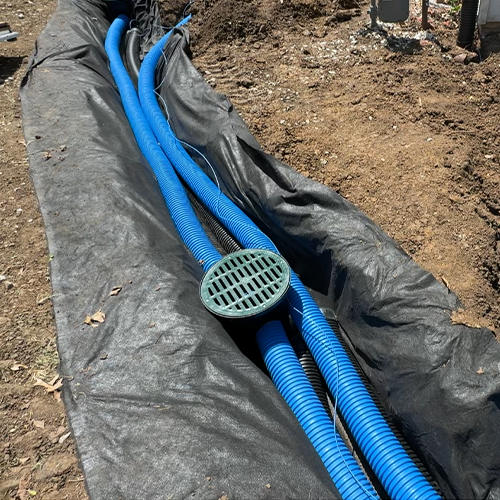 Pipe laid in French drain trench